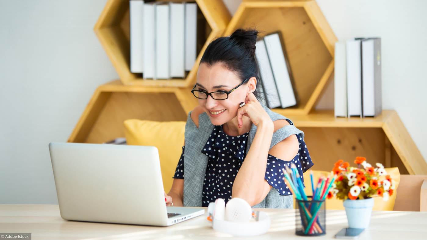 Happy excited successful Beautiful businesswoman triumphing in modern office with laptop, success happy pose